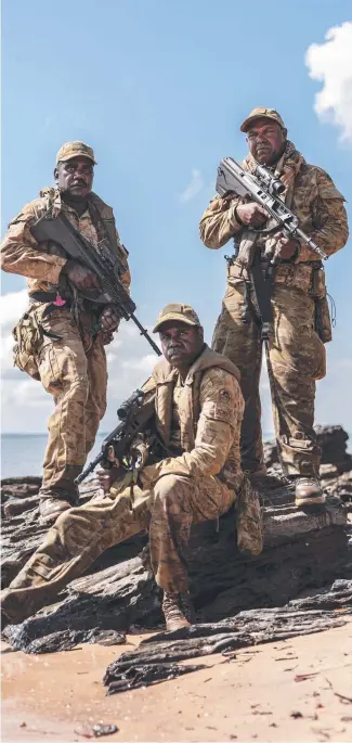  ?? ?? Private Peter Puruntatam­eri, Private Blake Djammar Carter and Private Misman Kris pictured on the beach of Milikapiti, Tiwi Islands. Picture: Dylan Robinson