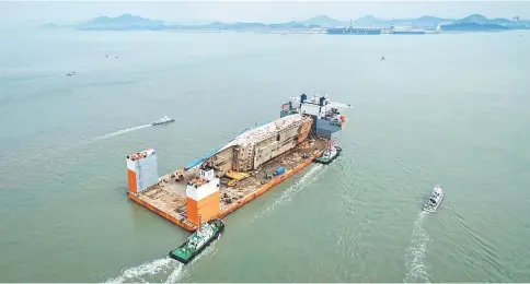  ??  ?? The wreck of the Sewol ferry arrives at a port in Mokpo. — AFP photo