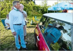  ?? DANA JENSEN/THE DAY ?? Actor Don McGregor of Madison receives help with his tie from crew member Bob Harding of Norwich while preparing to perform in Neil Simon’s “Last of the Red Hot Lovers,” presented by East Lyme Parks & Rec and Senior Center’s Pop-up Summer Stock Theatre...