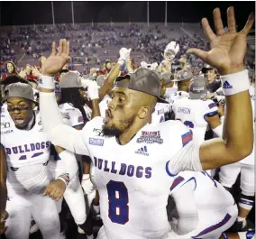  ?? [HENRIETTE WILDSMITH/ THE SHREVEPORT TIMES VIA AP] ?? Louisiana Tech's J'Mar Smith celebrates with teammates after winning the Independen­ce Bowl on Thursday night against Miami. Tech won 14-0, posting the first shutout in Independen­ce Bowl history.