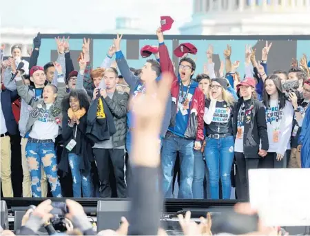  ?? MIKE STOCKER/SOUTH FLORIDA SUN SENTINEL ?? Marjory Stoneman Douglas High School students wave to the crowd that gathered in Washington, D.C., for the March for Our Lives rally in the wake of the shooting at the Parkland high school.