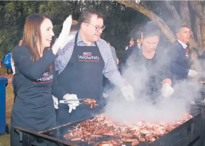  ?? Photo / NZME ?? Prime Minister Jacinda Ardern has wielded the barbecue tongs for Waitangi Day breakfast for the last time.