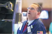  ?? RICHARD DREW/ASSOCIATED PRESS ?? Specialist Anthony Matsic works at his post on the floor of the New York Stock Exchange on Monday. Stocks finished broadly lower in trading on Wall Street amid investor concerns that the U.S.-China trade war may be worsening.