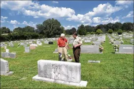  ?? CONTRIBUTE­D BY REBECCA BREYER ?? Deputy Mike Sullivan (right) and Frank Lott Jr. stand by Polk County Sheriff Frank Lott’s gravestone in Cedartown on Aug. 18. Many in law enforcemen­t believe they let Lott’s killer slip from their grasp.