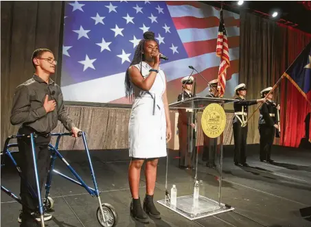  ?? Photos by Gary Fountain / Contributo­r ?? Olutomilol­a Akinwanden of the Kinder High School for the Performing and Visual Arts sings the national anthem at Mayor Sylvester Turner’s annual State of the City address on Monday. At left is Jacob Hurst of Theatre Under the Stars River Kids.
