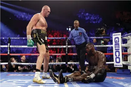  ??  ?? Tyson Fury knocks down Deontay Wilder in the fifth. Photograph: Al Bello/Getty Images