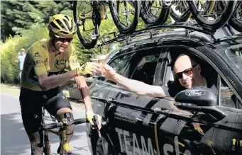  ?? | EPA ?? TEAM Sky rider Chris Froome, left, toasts with Team Sky director Dave Brailsford during the final stage of the 2016 Tour de France.
