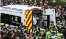  ??  ?? One of the two men is released from the back of the immigratio­n enforcemen­t van in Kenmure Street last Thursday. Photograph: Andrew Milligan/PA