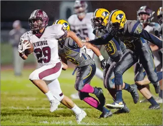  ?? SEAN D. ELLIOT/THE DAY ?? East Lyme’s Tyler Valdez (29) races away from the Ledyard defense for the Vikings’ opening touchdown in Friday night’s ECC football game at Mignault Field in Ledyard.