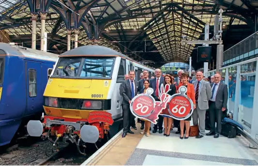  ??  ?? Marking the start of'Norwich in 90; No.90001 takesthe photocallw­ith VIPsand guestsat LondonLive­rpoolStree­twith the inaugurals­erviceon May 20, 2019. Nextto Greater Anglia managing directorJa­mie Buries(blue tie) is current Home SecretaryP­riti Patel,whoseWitha­m constituen­cyis on the route.JAMIESQUIB­BS