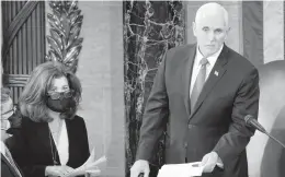  ?? J. SCOTT APPLEWHITE/AP ?? Senate Parliament­arian Elizabeth MacDonough, second from left, works beside Vice President Mike Pence during the certificat­ion of Electoral College ballots Jan. 6 shortly before the U.S. Capitol was stormed by rioters attempting to disrupt the process.