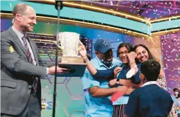  ?? ALEX BRANDON/AP ?? Harini Logan celebrates with her family Thursday after winning the Scripps National Spelling Bee in Maryland. It’s the first national title for the 14-year-old Texan.