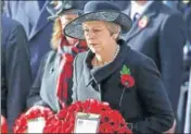  ?? REUTERS ?? ■ Left: French President Emmanuel Macron greets US President Donald Trump in Paris; Top: British Prime Minister Theresa May lays a wreath at the Cenotaph in Westminste­r, London.