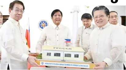  ?? PHOTOGRAPH COURTESY OF FFCCCII ?? PRESIDENT Ferdinand Marcos Jr. receives a model barrio school from FFCCCII president Dr. Cecilio Pedro (right) and executive vice president Victor Lim during the induction of officers of the charity organizati­on in Malacañang Palace in June.