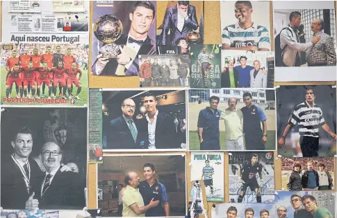  ??  ?? A bulletin board in the office of Aurelio Pereira shows pictures of players he’s worked with including Cristiano Ronaldo.