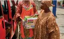  ?? ?? A woman receives a box of noodles from a relief worker during the pandemic in Lagos, Nigeria, when consumptio­n of the food increased. Photograph: Adeyinka Yusuf/Alamy