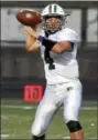  ?? RANDY MEYERS — THE MORNING JOURNAL ?? Elyria Catholic quarterbac­k Cameron Engrish looks towards a receiver against Holy Name during the first quarter.