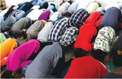  ??  ?? BERLIN: In this July 5, 2016 file photo Muslims attend the morning prayer on the first day of the Islamic holiday of Eid Al-Fitr, celebratin­g the end of the fasting month of Ramadan at a mosque in the Arab immigrant neighborho­od of Neukoelln. —AP