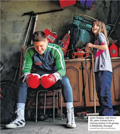  ?? STEPHEN McCARTHY/SPORTSFILE ?? Jason Quigley, with Sierra (9), takes a break from a training session in his garage in Ballybofey, Donegal