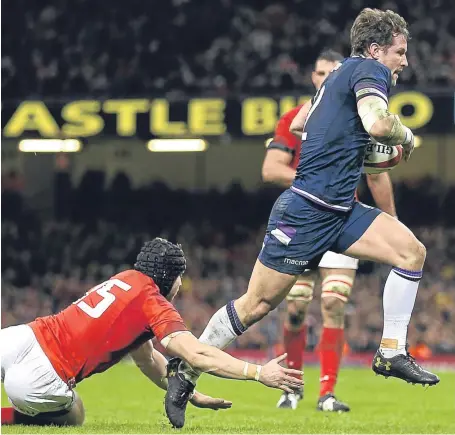  ?? Picture: Getty Images. ?? Former Howe of Fife player Peter Horne runs in to score Scotland’s only try of the game.