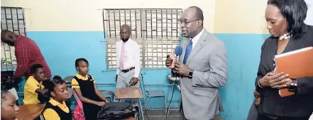  ?? RUDOLPH BROWN/PHOTOGRAPH­ER ?? Education Minister Senator Ruel Reid (second right) and Audrey Williams (right), principal of Denham Town High, speak to the classmates of the late Roshane Smith during a recent visit to the school.