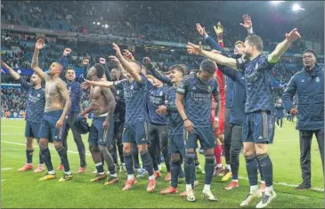  ?? AP ?? Real Madrid players celebrate victory in front of their fans at the Etihad Stadium on Wednesday.