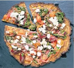  ?? DEB LINDSEY/FOR THE WASHINGTON POST ?? Cauliflowe­r pizzas with chard and olives.
The cauliflowe­r “flour” can be refrigerat­ed for up to 3 days. The baked pizza crusts can be refrigerat­ed for up to 1 week or frozen for up to 3 months. Reheat in a 300 degree oven to crisp them up again before...