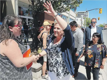  ?? CLIFFORD SKARSTEDT/EXAMINER ?? Ontario NDP leader Andrea Horwath waves to supporters next to local NDP candidate Sean Conway during a campaign stop Saturday.