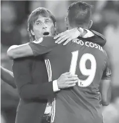  ?? — Reuters photo ?? Antonio Conte celebrates with supporters after Diego Costa scores their late winning goal during the English Premier League football match between Chelsea and West Ham United at Stamford Bridge in London.