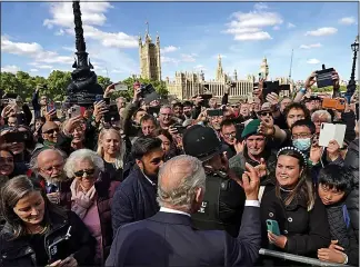  ?? ?? RAISING MORALE: King Charles meets people queuing on the South Bank