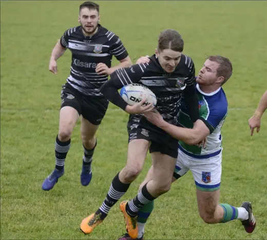  ?? Pictures: Ken Finegan ?? Robert Williams of Dundalk is tackled by Conor Jennings (Suttonians) at Mill Road last Saturday.