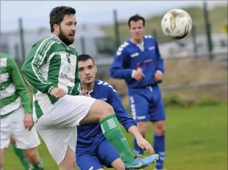  ??  ?? Daniel Lang in possession for Strand Celtic. Pic: Carl Brennan.