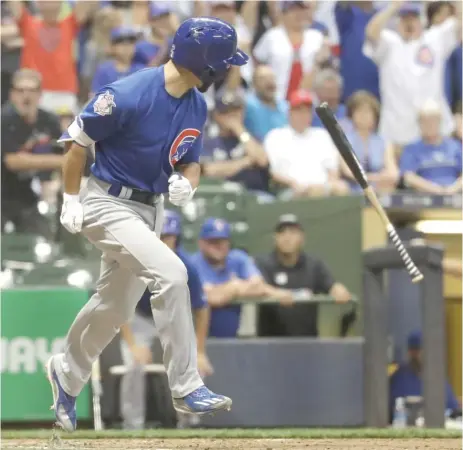  ?? | AP ?? Pinch hitter Tommy La Stella flips his bat and heads to first after forcing in the go- ahead run on awalk with the bases loaded in the 10th inning.