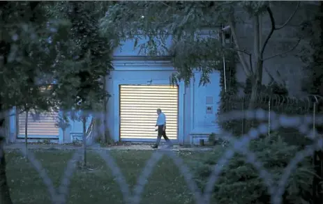  ??  ?? A Turkish police officer walks inside the property of the residence of the Saudi Consul General Mohammed al-Otaibi as Turkish police conducted a search Wednesday in Istanbul.