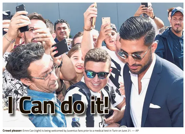  ?? — AP ?? Crowd pleaser: Emre Can (right) is being welcomed by Juventus fans prior to a medical test in Turin on June 21.