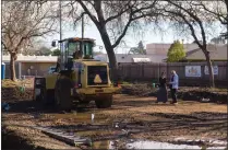  ?? ?? Chico Housing Action Team Executive Director Nicole Drummond, left, speaks to volunteer Robert Trausch nearby constructi­on equipment Wednesday, at the Everhart Village project site in Chico.