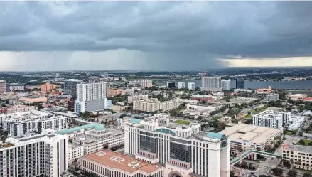  ?? GREG LOVETT/PALM BEACH POST ?? A storm moves toward downtown West Palm Beach in late September 2023. A mix of torrential rain and damaging winds is forecast to thrash the region today and Saturday.