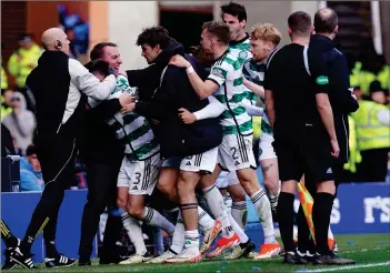  ?? ?? Brendan Rodgers and his players rejoice after Adam Idah’s strike