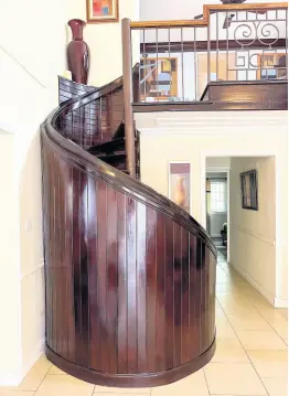  ?? ?? A metal spiral staircase enclosed in solid wood.