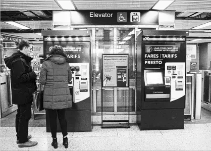  ?? NATHAN DENETTE THE CANADIAN PRESS ?? People pay at Presto machines undergroun­d in the TTC subway portals in Toronto on Tuesday, Dec. 4, 2018.