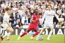  ??  ?? Liverpool’s Sadio Mane drives the ball between Leeds United’s Kalvin Phillips (left), and Diego Llorente (right), during the English Premier League soccer match between Leeds United and Liverpool at Elland Road, Leeds, England. (AP)