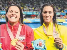  ?? Picture: GETTY IMAGES ?? Winners are grinners but what was said between England gold medallist Aimee Willmott and Aussie bronze medalist Blair Evans after the 400m individual medley final?