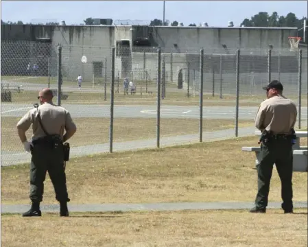  ?? AP PHOTO ?? In this Aug. 17, 2011, file photo, correction­al officers keep watch on inmates on the recreation yard at Pelican Bay State Prison near Crescent City.