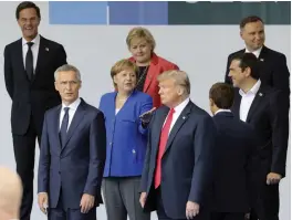  ?? — AP ?? German Chancellor Angela Merkel ( second left), Nato secretary general Jens Stoltenber­g ( left) US President Donald Trump ( centre right), French President Emmanuel Macron ( right back to camera) and Greek Prime Minister Alexis Tsipras ( right) stand prior to a family picture ahead of the opening ceremony of the Nato summit, at the Nato headquarte­rs in Brussels on Wednesday.