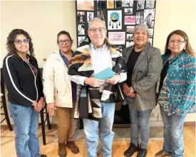  ?? PROVIDED ?? Chairman Joseph Rupnick (center) stands with other Nation members after signing over 130 acres in DeKalb County in trust to the federal government, which then set it aside as a federal Indian reservatio­n — the first in Illinois