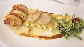  ??  ?? Seared scallops and scampi.