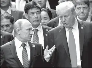  ?? The Associated Press ?? PRESIDENTI­AL TALK: In this Nov. 11, 2017, file photo, President Donald Trump, right, and Russia President Vladimir Putin talk during the family photo session at the APEC Summit in Danang. The Trump administra­tion is opening the door to a potential...