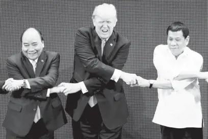  ??  ?? US President Donald Trump, Vietnam Prime Minister Nguyen Xuan Phuc, and President Duterte perform the group ASEAN handshake in the opening ceremony of the Associatio­n of Southeast Asian Nations Summit in Pasay City.