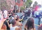  ?? [USA TODAY] ?? People chant during a protest at the scene of a police shooting in Lancaster, Pa., on Sunday. A man was shot by police earlier in the day after a reported domestic dispute, police said. The man, identified as Ricardo Munoz, was pronounced dead at the scene.