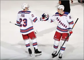  ?? Elsa / Getty Images ?? The Rangers’ Ryan Strome, right, is congratula­ted by teammate Adam Fox after Strome scored an empty- net goal in the third period against the New Jersey Devils at Prudential Center on Saturday in Newark, N. J.